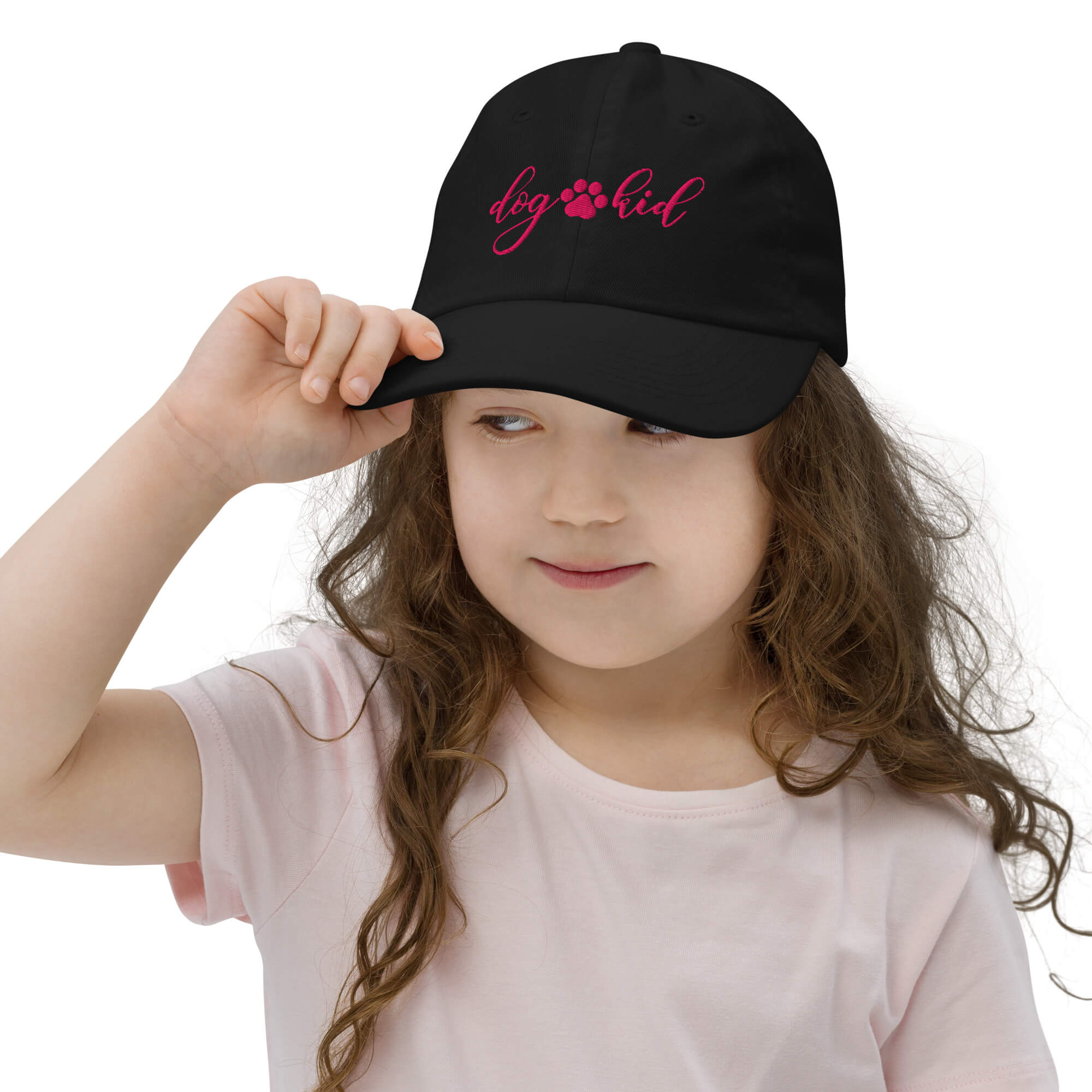 Girl wearing black DOG KID baseball cap with flamingo embroidery and adjustable fit