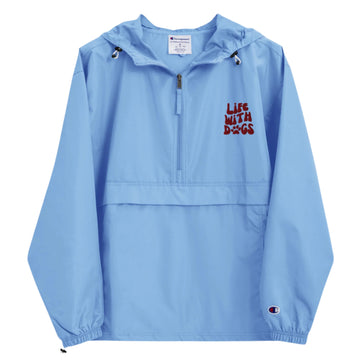 Light blue Champion windbreaker on white background showing LIFE WITH DOGS puff embroidery and weather-resistant design